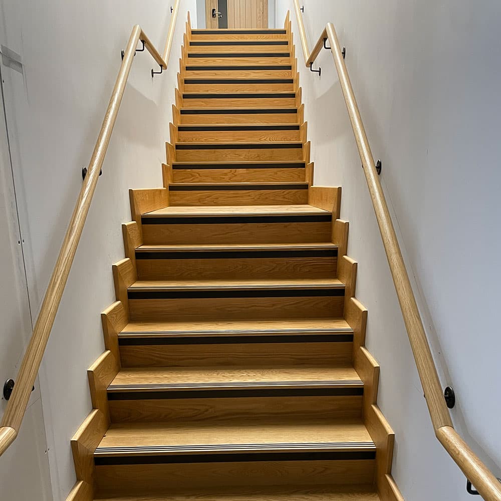 Wooden staircase with a shaped timber handrail